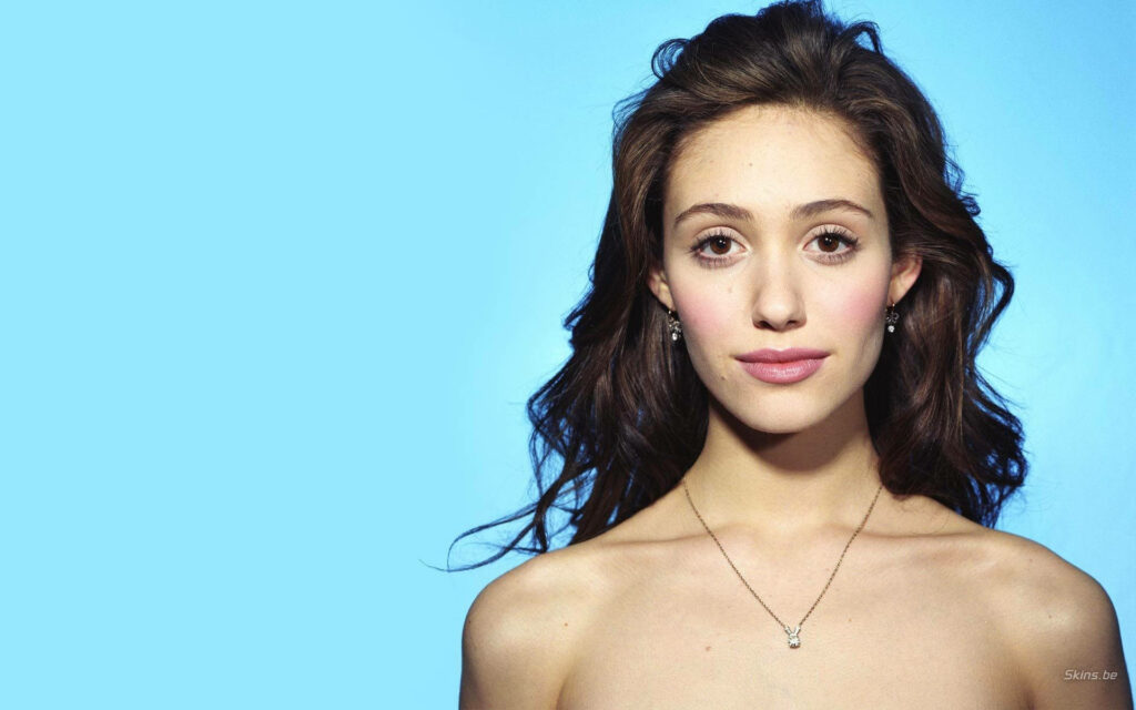 Emmy Rossum close-up portrait with soft lighting smooth blue background natural beauty serene Wallpaper