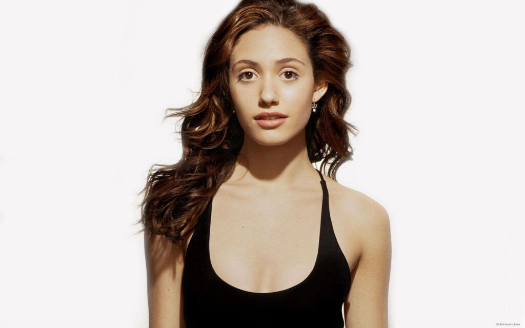 Emmy Rossum minimalist portrait with wavy brown hair and black outfit on white background wallpaper