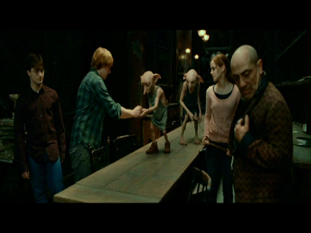 Emotional Dobby & Ron Weasley Wallpaper: Dramatic Scene Background