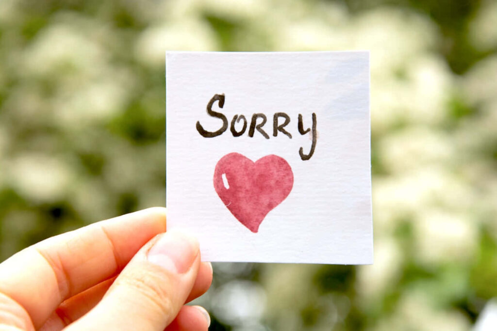 Emotional 'Sorry' Note with Heart on Soft Natural Wallpaper