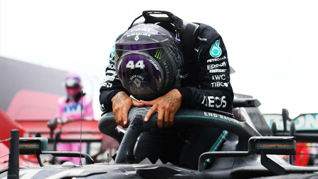 Emotional Lewis Hamilton: Reflective Moment Wallpaper Background