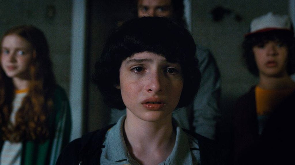 Finn Wolfhard as Mike Wheeler emotional scene with Max Mayfield and Dustin Henderson Stranger Things Wallpaper