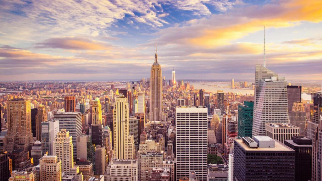 Skyscrapers Galore: Manhattan's Iconic Empire State Building Steals the Spotlight in This Breathtaking Aerial Shot Wallpaper