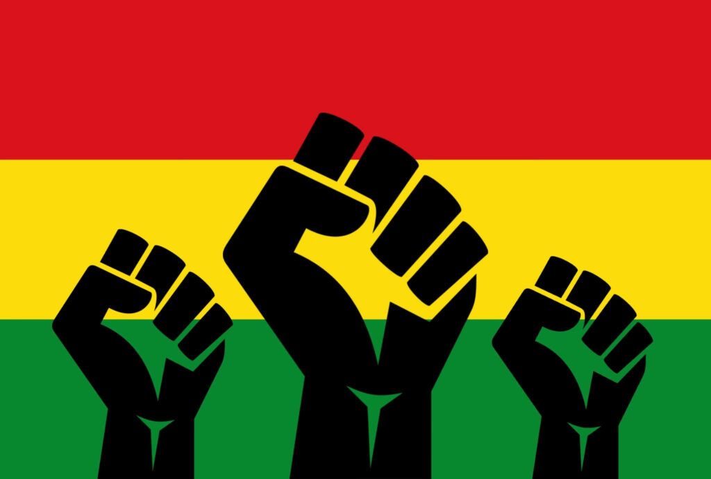 Three raised fists over Pan African flag colors red yellow green symbolizing unity and empowerment Wallpaper