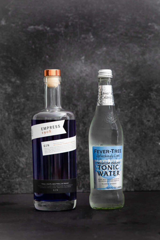Elegant still life of Empress 1908 Gin bottle and Fever-Tree Tonic Water on dark background Wallpaper