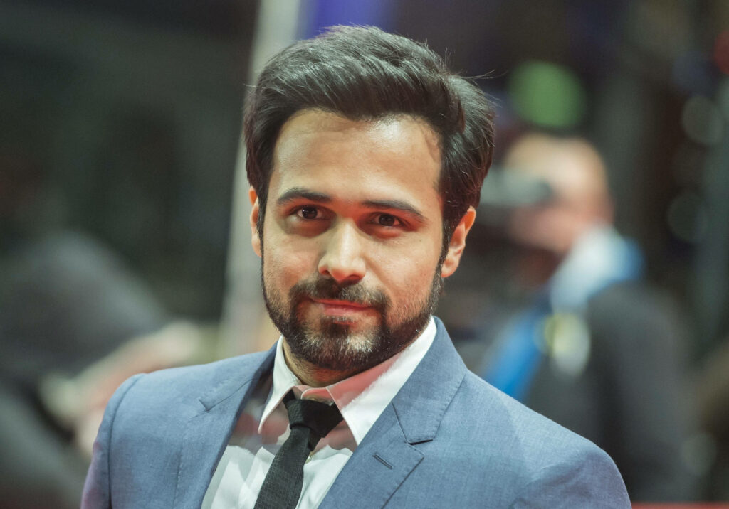 Emraan Hashmi in blue suit and black tie at red carpet event with confident charismatic look Wallpaper