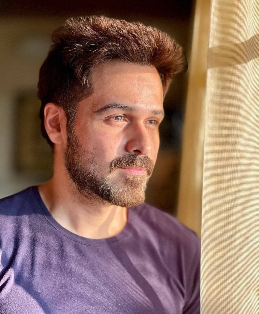 Emraan Hashmi portrait in warm golden sunlight near window with groomed beard dark t-shirt wallpaper