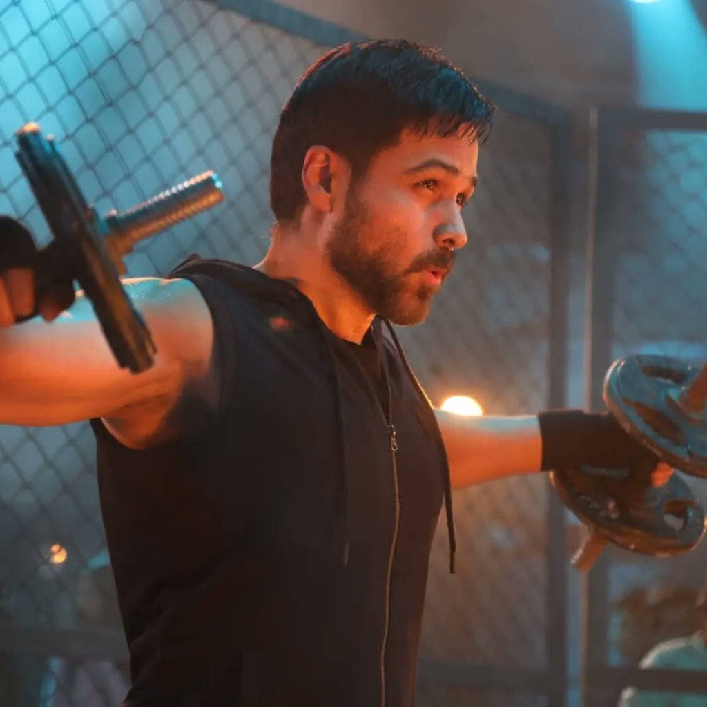 Emraan Hashmi intense lateral raises workout black hoodie gym orange blue lighting wallpaper