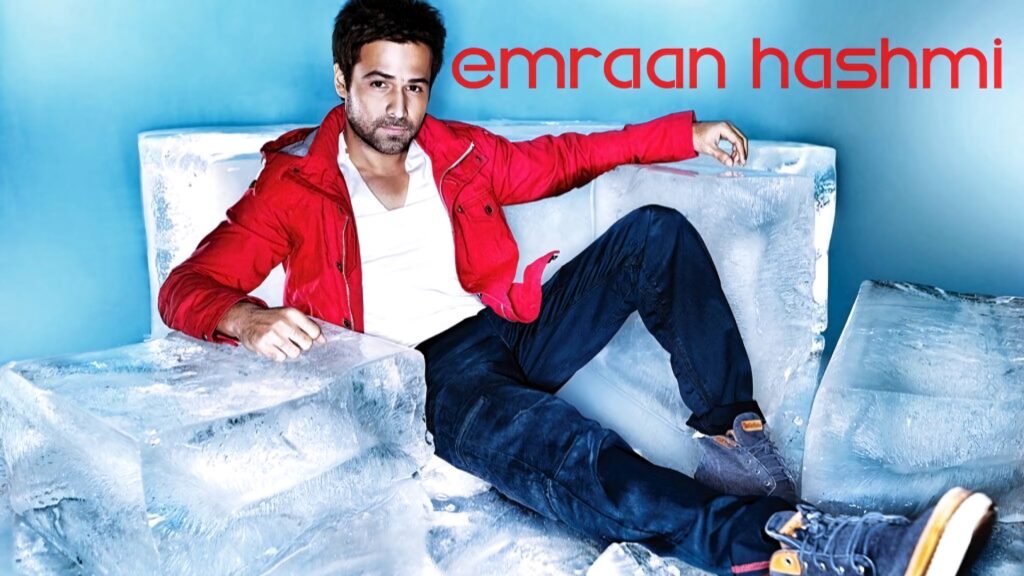 Emraan Hashmi in red jacket on ice blocks with blue icy background striking edgy fashion look Wallpaper