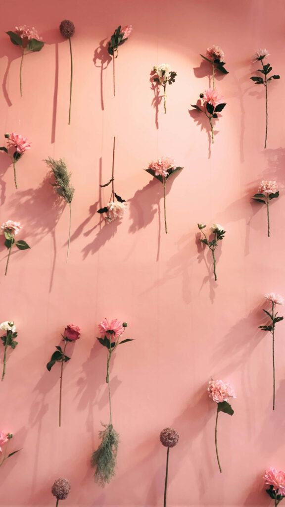 Floral Delight: Elevate Your Phone's Style with a Whimsical Light Pink Wallpaper