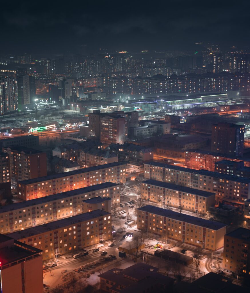 Enchanting Nighttime Snowy Cityscape Wallpaper Background