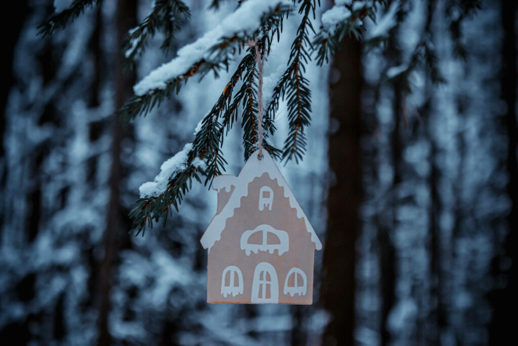 Gingerbread Delight: A Snowy Christmas Ornament on a Tree Wallpaper