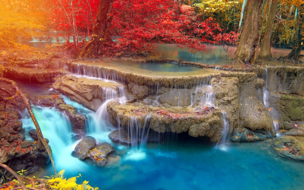 Enchanting Autumn Waterfall Cascades amid Vibrant Forest Foliage - Mesmerizing HD Background Picture Wallpaper