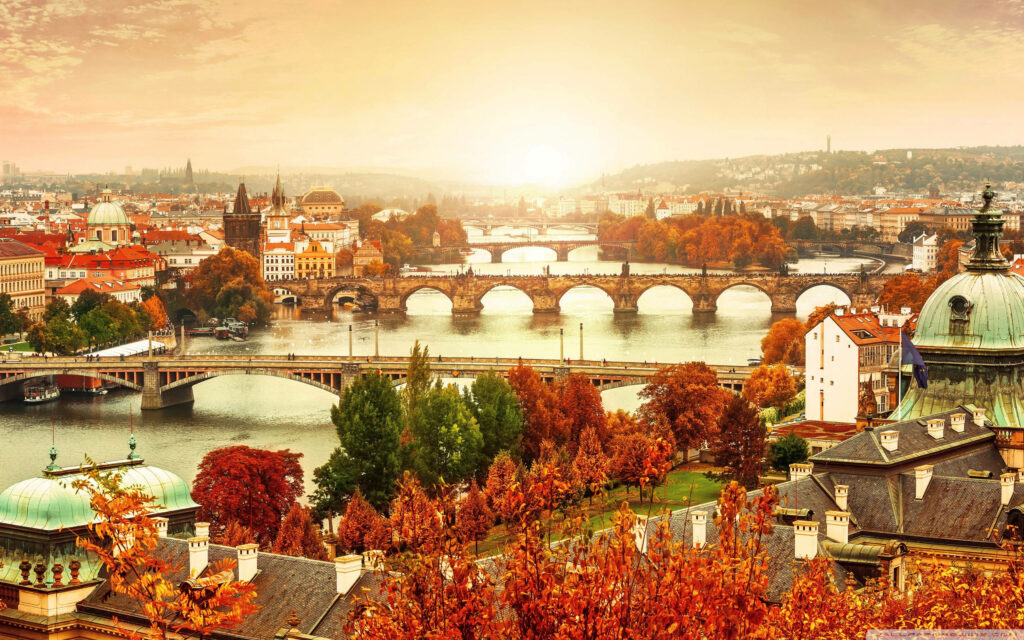Autumn Serenity: Prague's Enchanting Cityscape Embraced by Vibrant Colors as Dusk Beckons Wallpaper