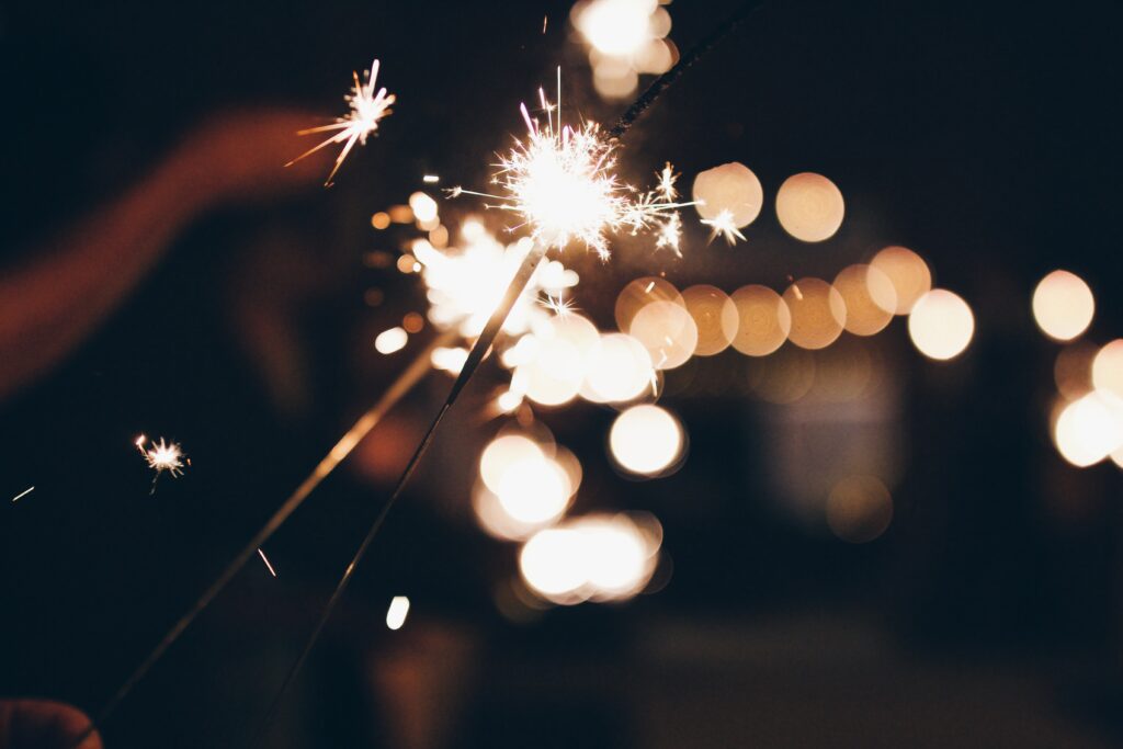 Enchanting Bengal Fire Sparklers Wallpaper - Dark Background Magic