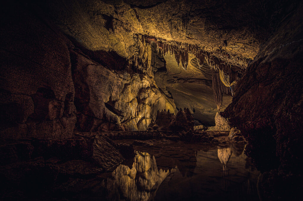 Enchanting Cave Wallpaper: Rugged Rocks & Stalactites Reflection