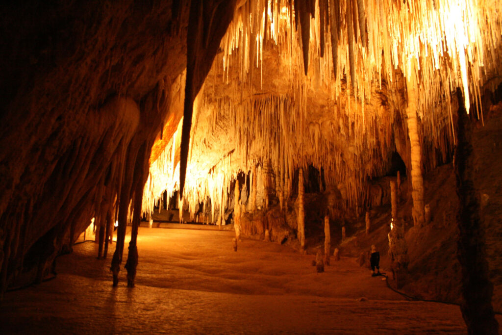 Mysterious Cave Landscape Wallpaper: Warm Glow & Stunning Natural Formations