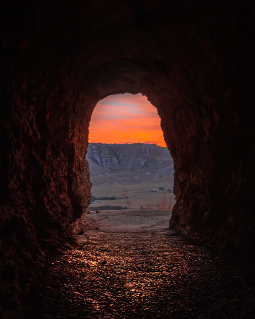 Cave View Sunset Wallpaper: Vibrant Colors & Rugged Landscape