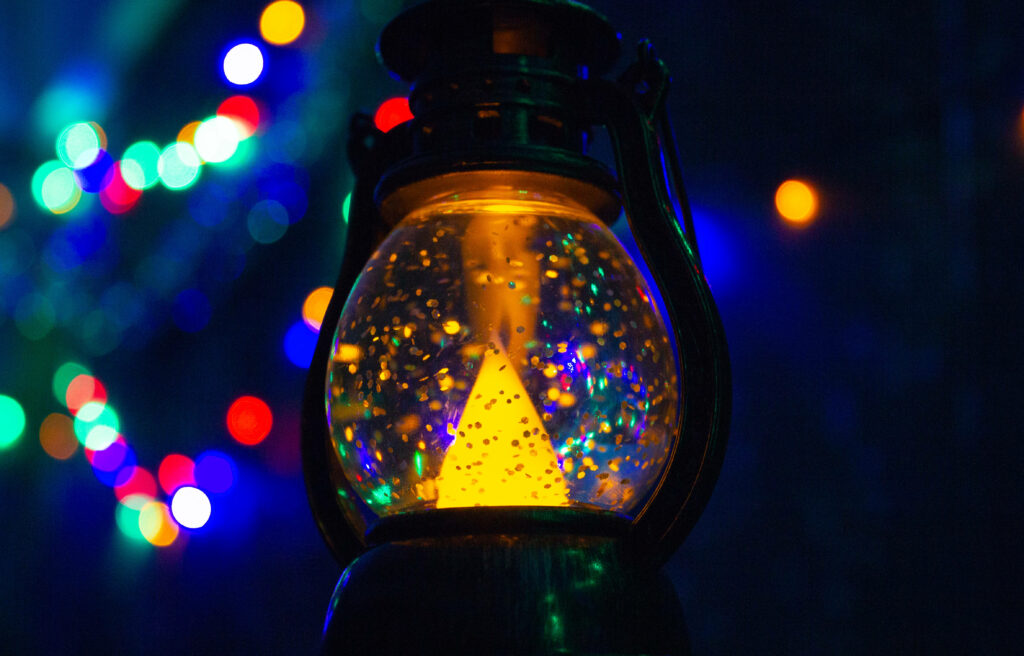 Glimmering Festive Radiance: Captivating Christmas Lantern Amidst a Vibrant Backdrop Wallpaper