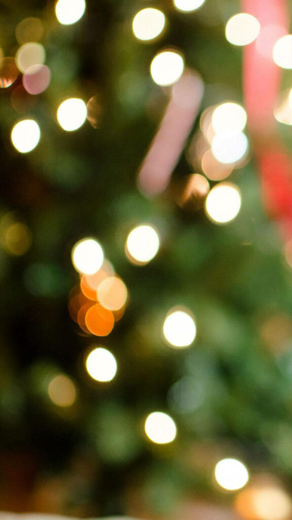 Enchanting Christmas iPhone Wallpaper with Soft Bokeh Lights