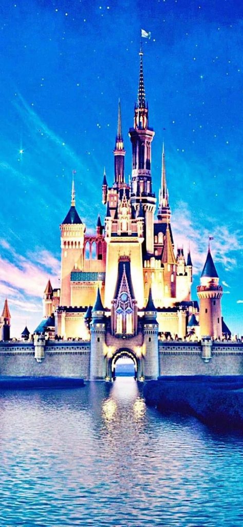 Cinderella Castle Disney World wallpaper glowing at twilight sky reflected on moat serene view