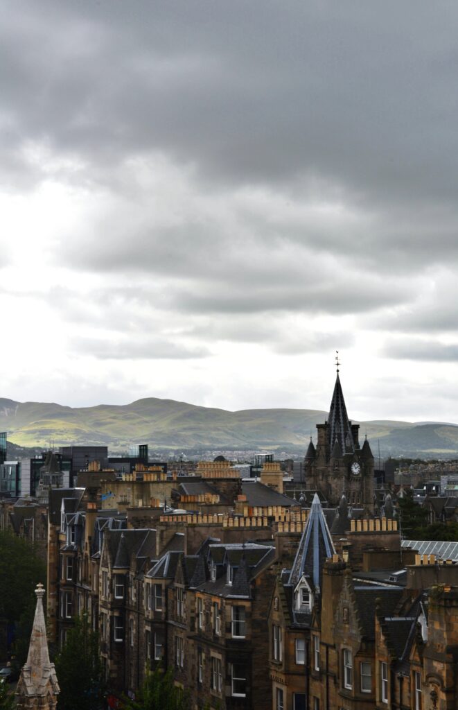 Enchanting Cityscape Wallpaper: Historic Buildings & Lush Mountains