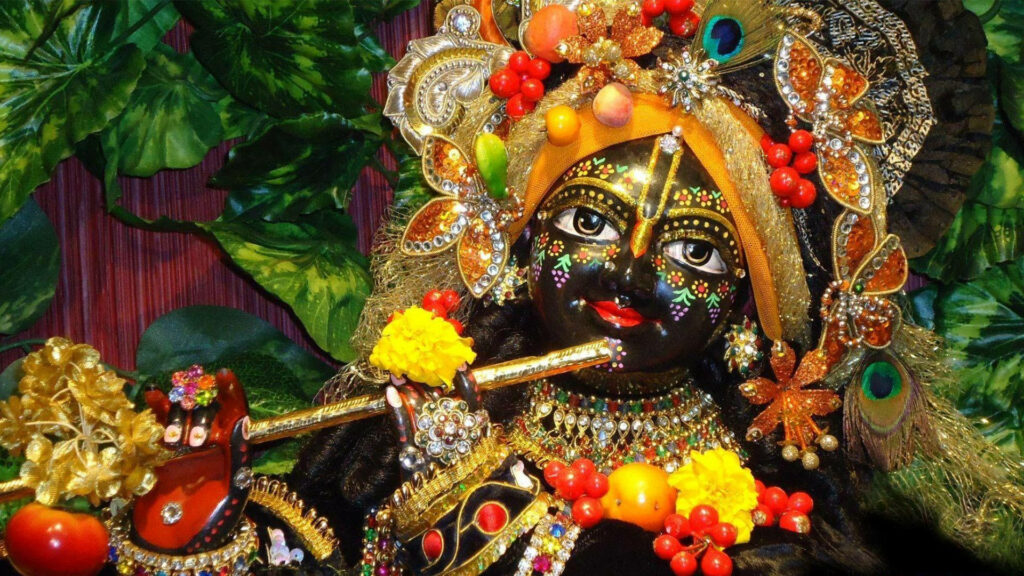 Vibrant and Ornate Dark Krishna Statue Exuding Musical Majesty Wallpaper