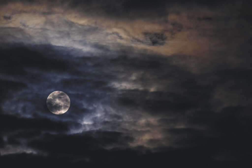 Enchanting Dark Moon Wallpaper: Dramatic Clouds & Mystical Glow