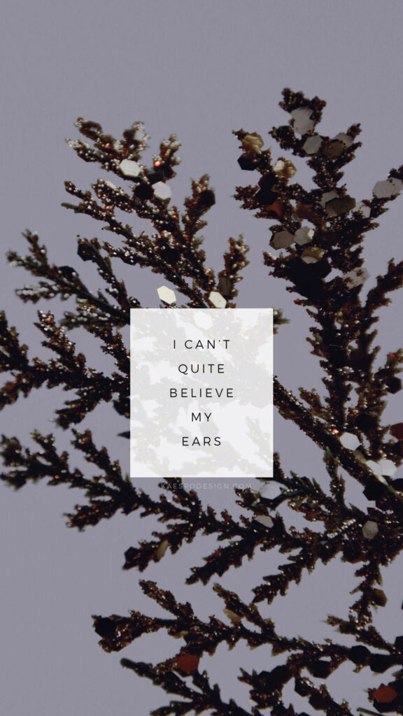Dreamy Tinsel Tree Branch with Whimsical 'I Can't Believe My Ears' Indie Phone Wallpaper
