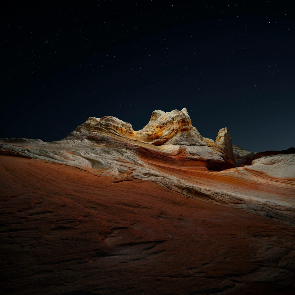 Night view of White Pocket Arizona sandstone formations under a vibrant starry desert sky Wallpaper
