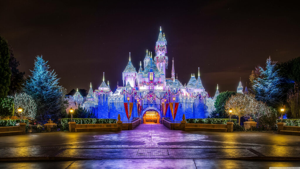 Enchanting Holiday Fairy Tale Castle Illuminated at Night Wallpaper