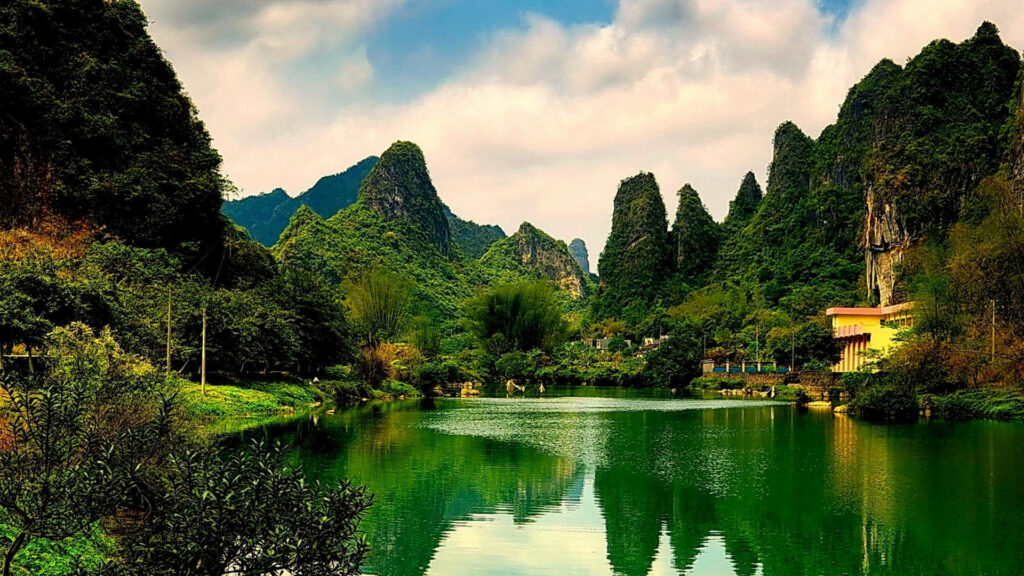 Enchanting Guilin: The Majestic Limestone Lake Embraced by Verdant Canopies Wallpaper