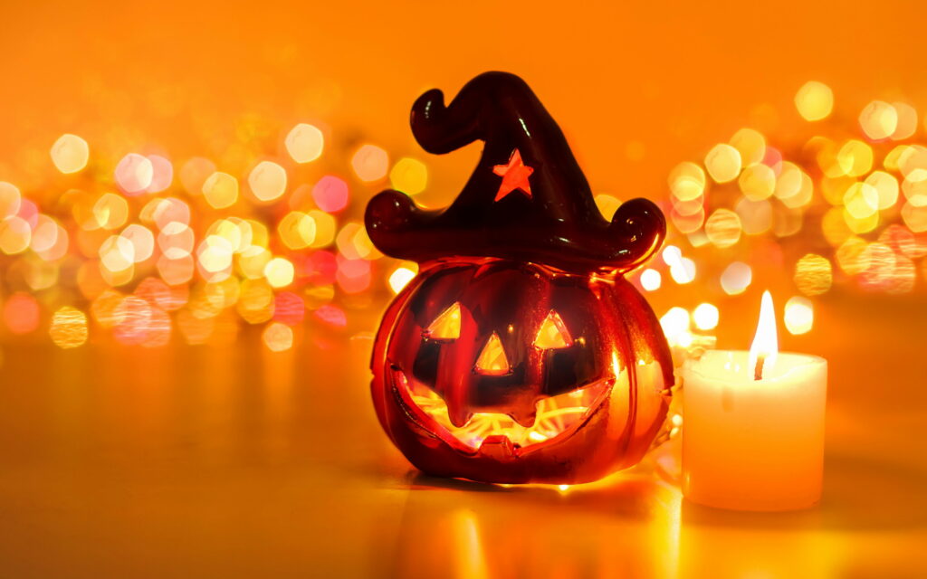 Enchanting Halloween Celebration: Illuminate the Night with Pumpkin Candles Wallpaper