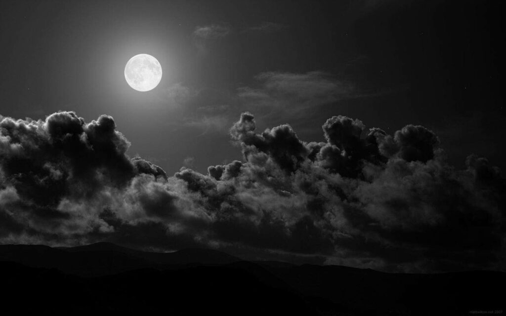 Mysterious Night: Enigmatic Moon Illuminating the Shadow-Laden Skies Wallpaper