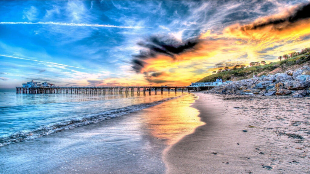 Surreal Sunset at Malibu Pier: An Enchanting 1440p Background Wallpaper