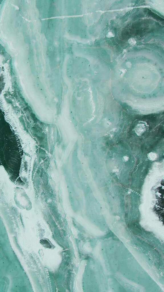 Mint Marvel: A Captivating Green Iphone Wallpaper with Tabletop Marbling Design in Shades of Leafy Greens and Hints of Tranquil White