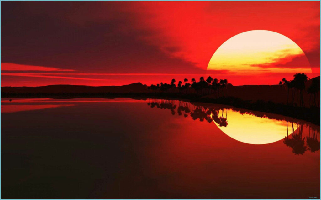 Mountain Majesty: a Breathtaking Sunset Reflected in Serene Waters Wallpaper