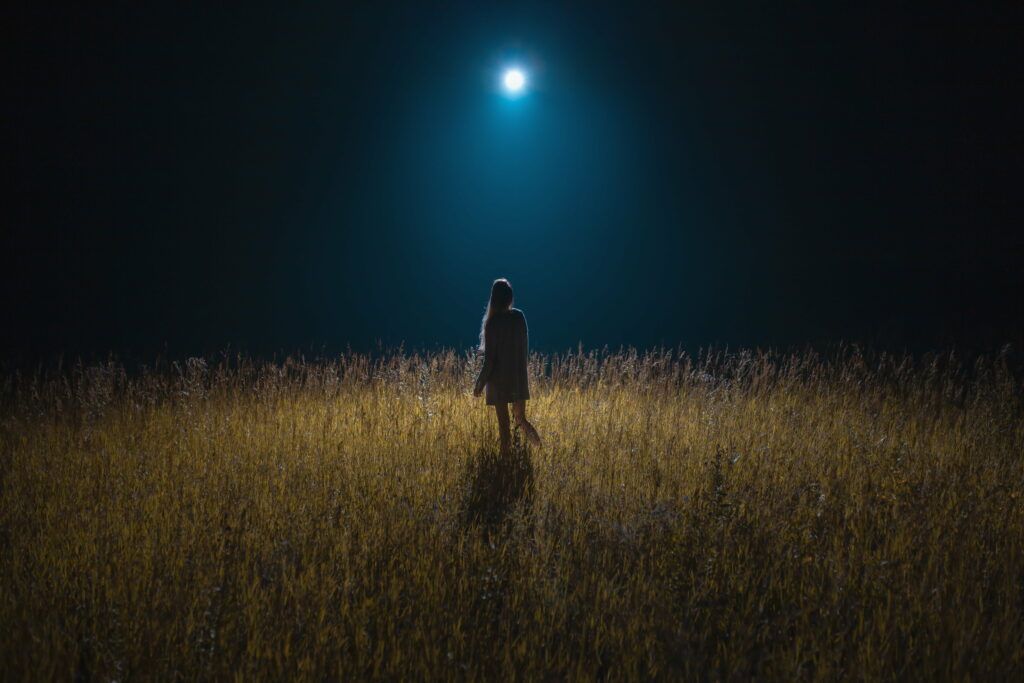 Moonlit Serenity: Girl Gazing at the Night's Cosmic Canvas in a Field - HD Wallpaper Background