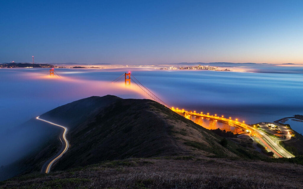 Golden Glow: Captivating Oceanic Landscape Transformed by Yellow Bridge Lights - HD Background Photo Wallpaper