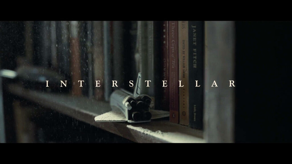 Enchanting Sci-Fi Adventure Unfolds Amidst Bookshelf Treasures: A Captivating Interstellar Film Opener Wallpaper