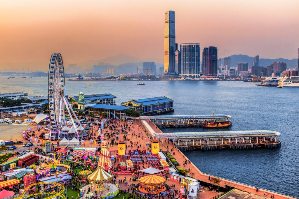 Enchanting Sunset Cityscape Wallpaper: Skyscrapers & Festive Pier