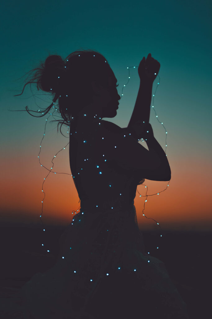 Enchanting Sunset Wallpaper: Woman Silhouette with String Lights