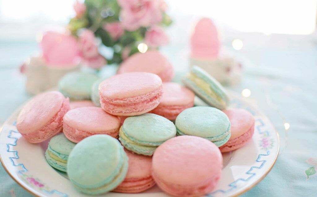 Whimsical Delight: A Dreamy Pastel Macaroon Wallpaper Set Against a Blurred Background
