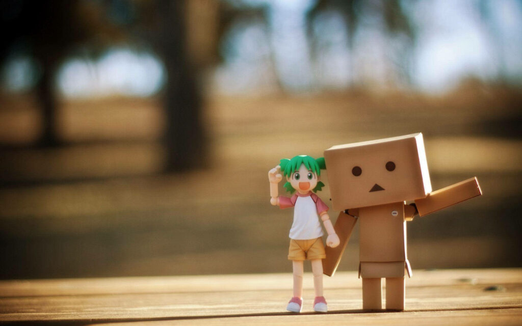Adorable Green-haired Girl and her Playful Box Action Figure: A Delightful Friendship in Macro Wallpaper