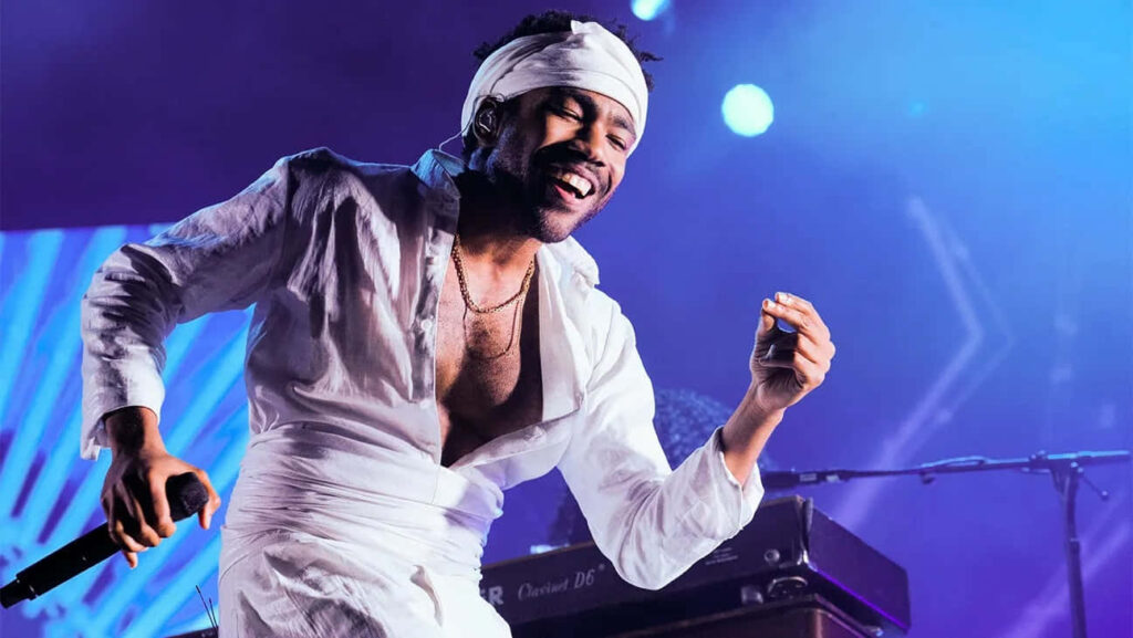Childish Gambino Live: Energetic Performance in White Outfit Wallpaper