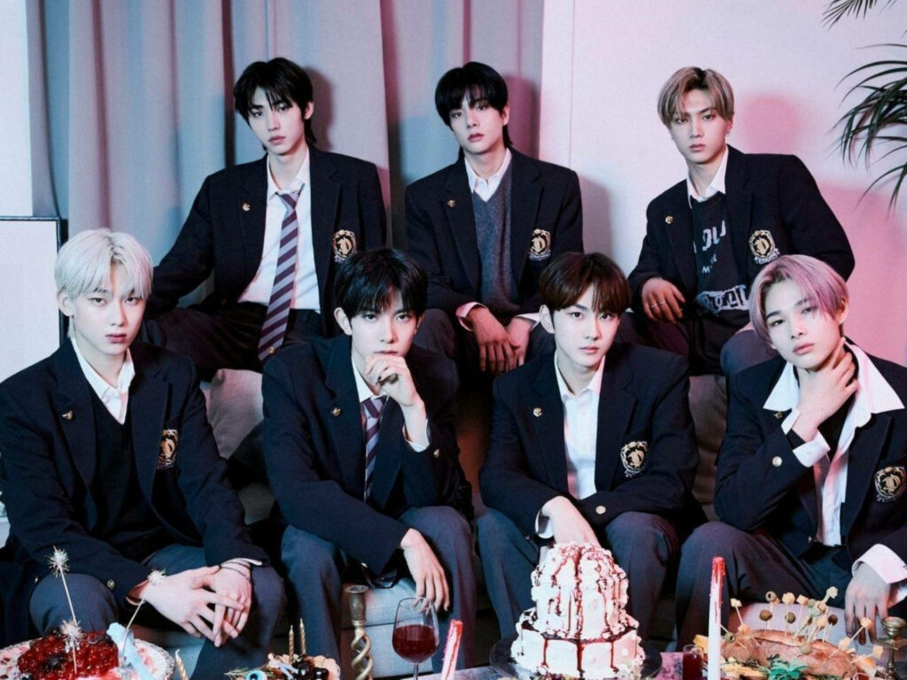 Enhypen schoolboys in sharp uniforms posing confidently in festive wallpaper background