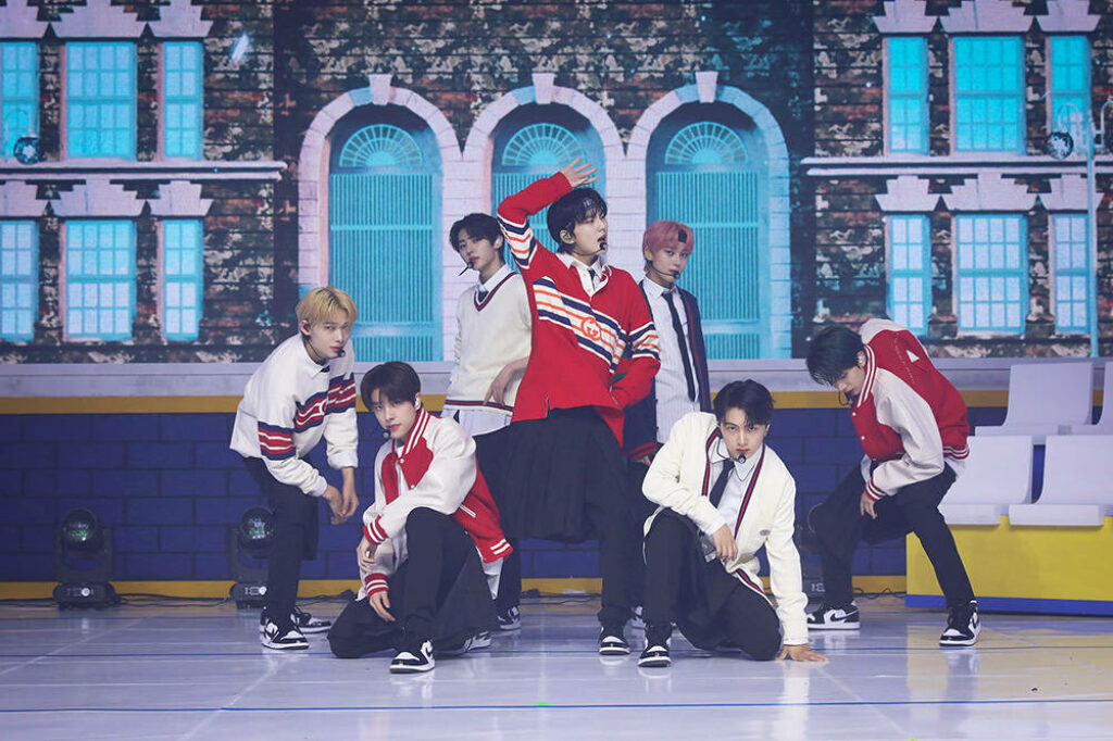 Enhypen performing Tamed Dashed in sporty outfits with vibrant backdrop energetic choreography Wallpaper