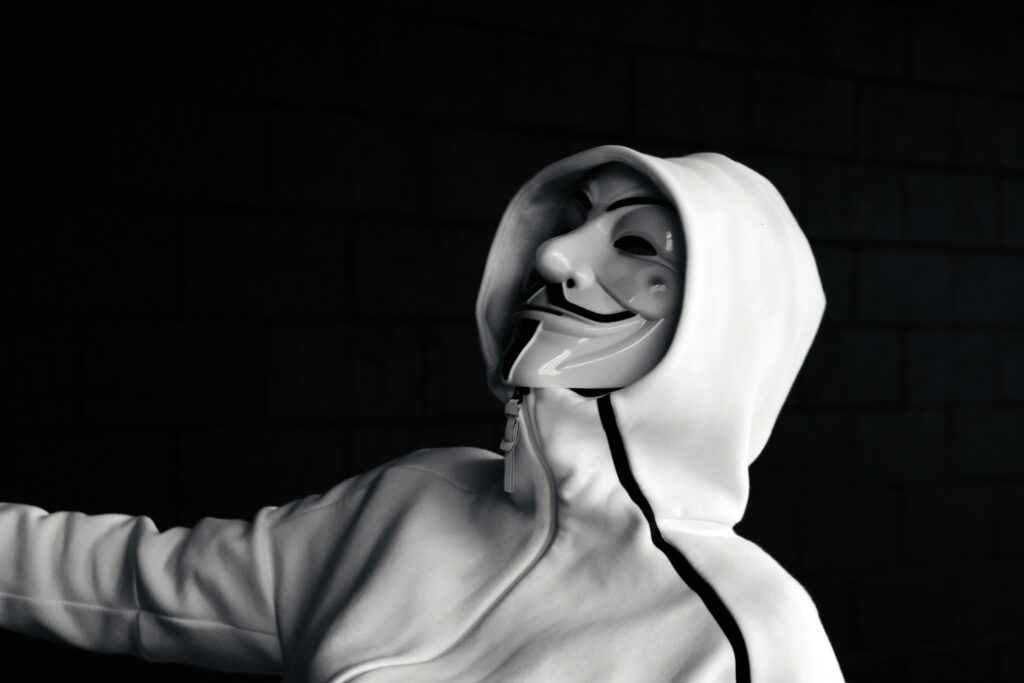 Anonymous Style Black and White Hooded Figure Wallpaper Background