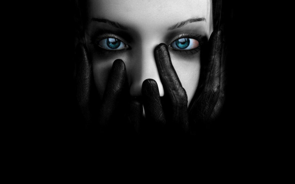Enigmatic Beauty: Dark Screen Wallpaper Revealing Veiled Woman with Piercing Blue Eyes and Black-Gloved Hands