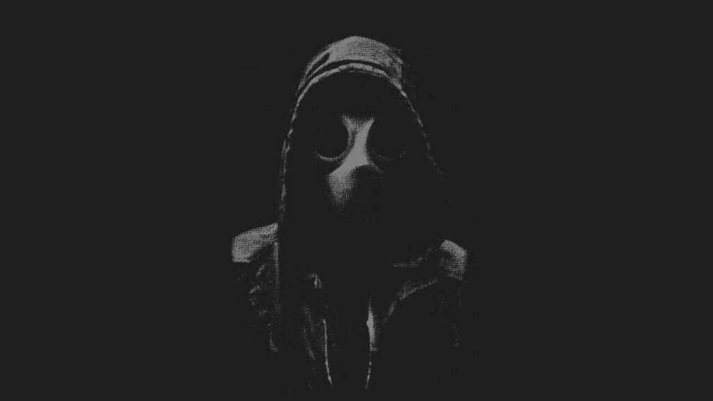 The Enigmatic Figure: Man Clad in Jacket and Gas Mask amidst Eerie Darkness captures attention with Static Background Wallpaper